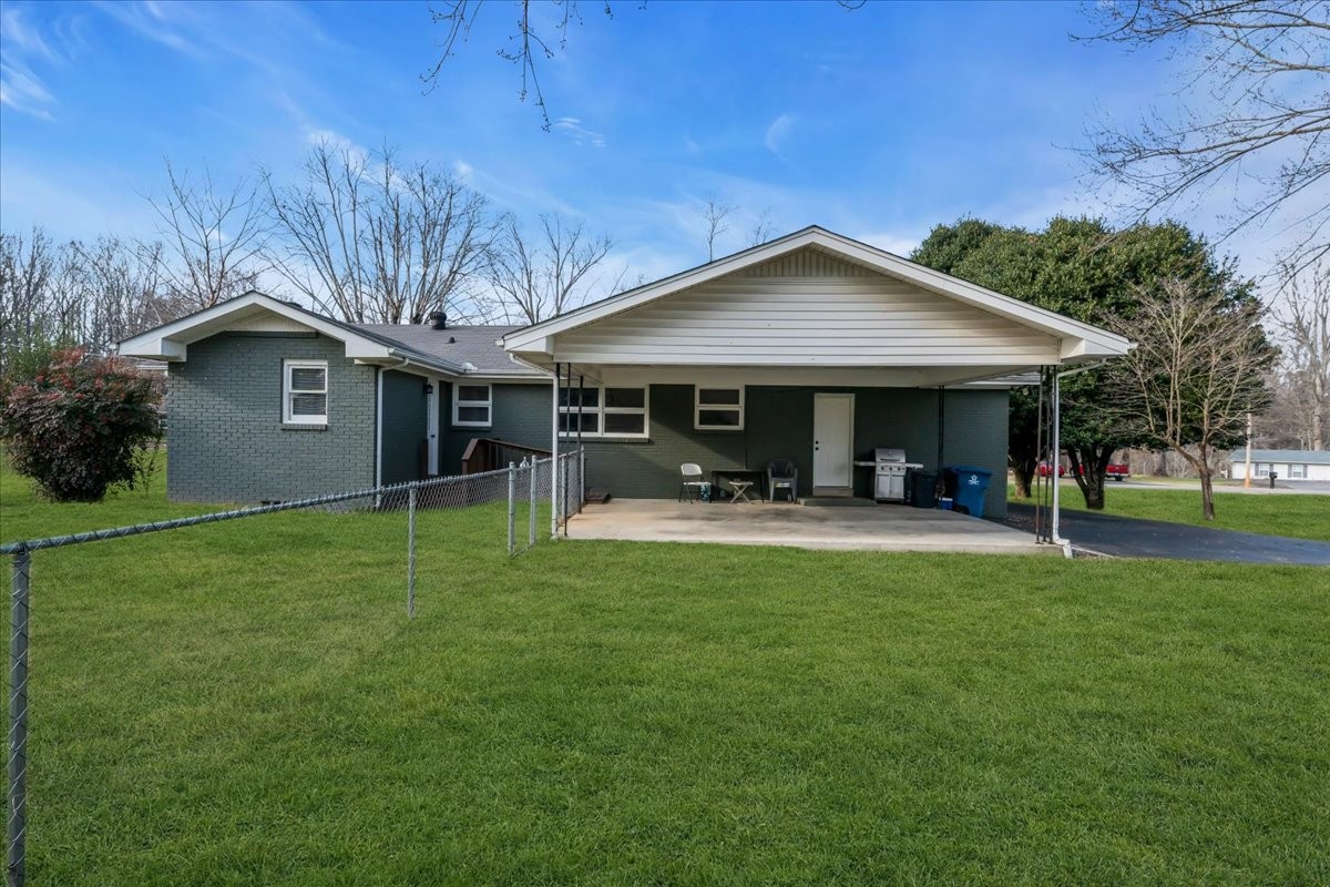 902 Sycamore Drive Manchester, TN 37355 - Photo 38 of 51 a view of a house with table and chairs under an umbrella
