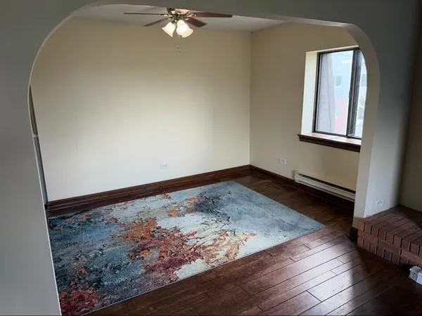 a view of a room with wooden floor and window