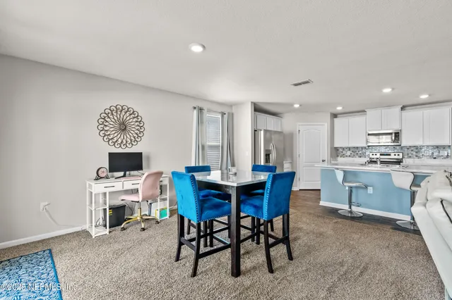 a view of a dining room with furniture