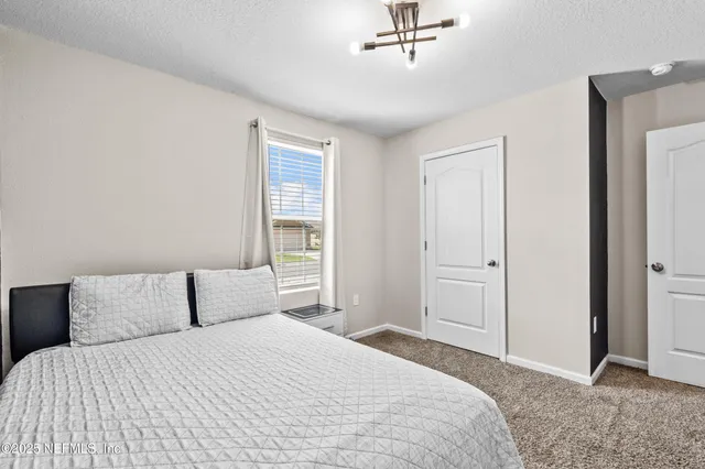 a bedroom with a bed and cabinets