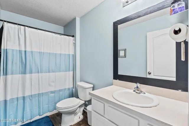 a bathroom with a sink toilet and a mirror