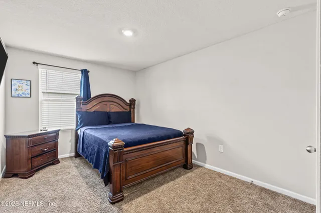 a room with a bed and a dresser