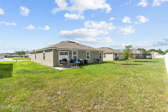 a front view of a house with yard and green space