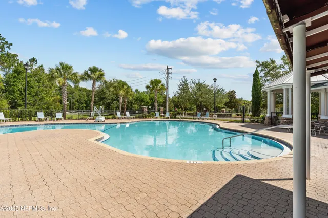 a view of a swimming pool with an outdoor seating