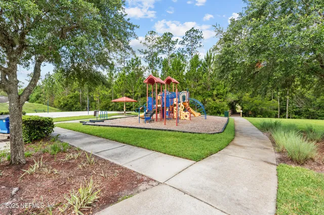 a view of a park with large trees