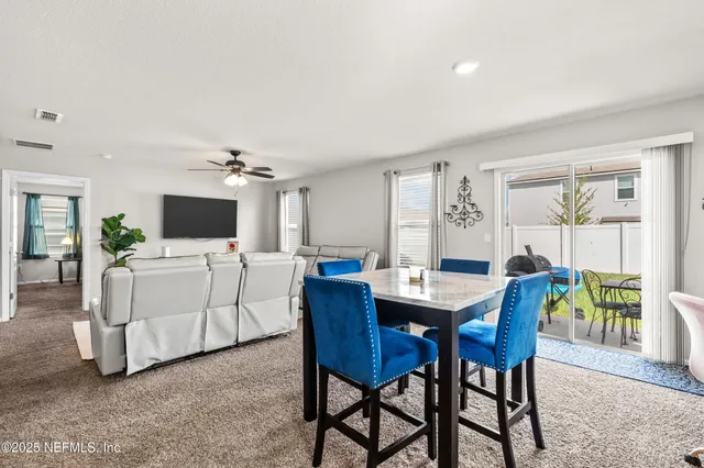 a view of a dining room with furniture and a livingroom