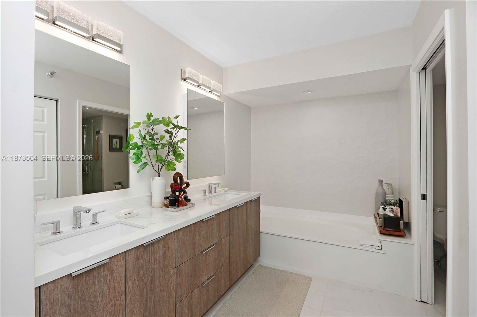 3530 Mystic Pointe Drive, Unit 2402 Aventura, FL 33180 - Photo 11 of 31 a bathroom with a sink vanity tub and shower