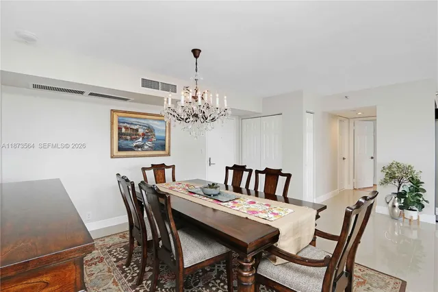a view of a dining room with furniture and chandelier
