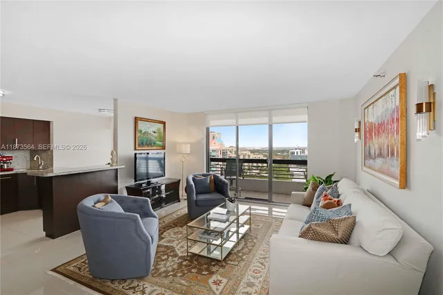 a living room with furniture and a floor to ceiling window