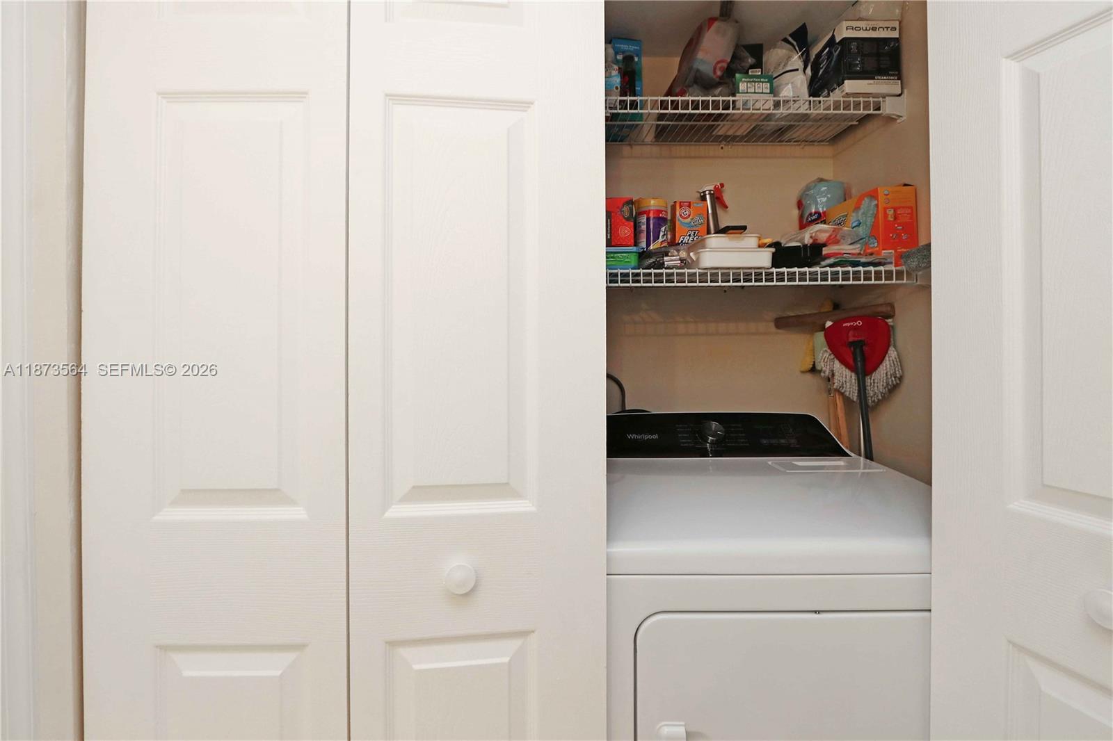 3530 Mystic Pointe Drive, Unit 2402 Aventura, FL 33180 - Photo 25 of 31 a utility room with dryer and washer