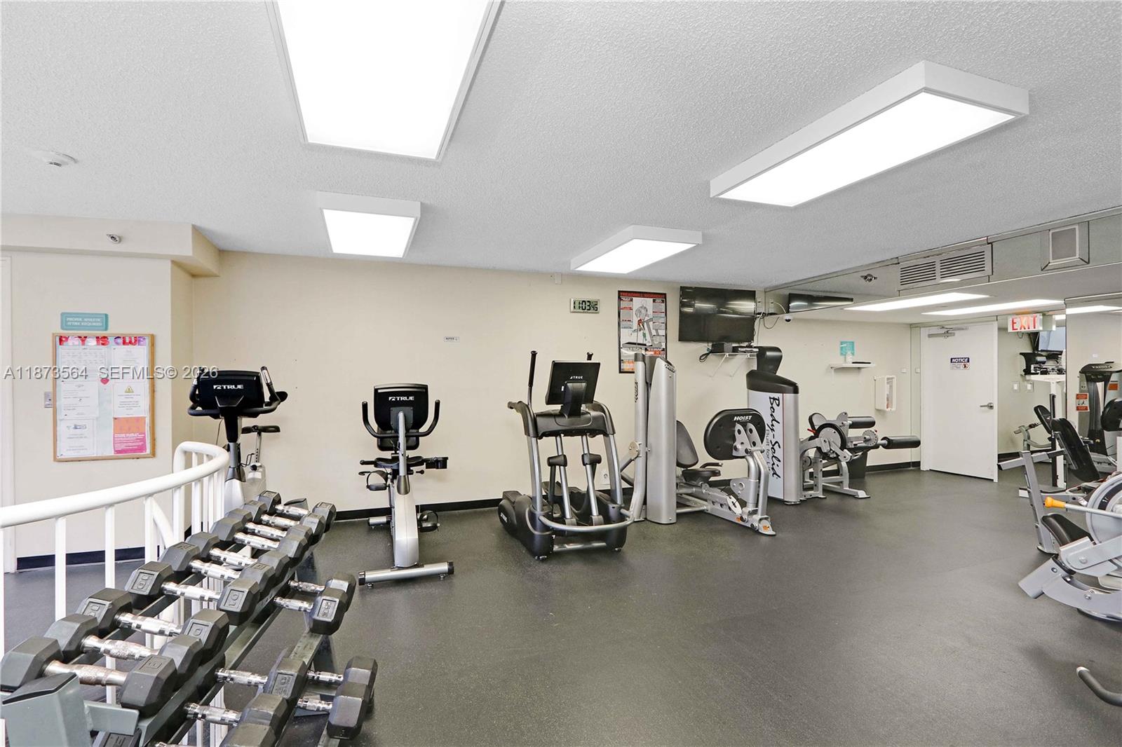 3530 Mystic Pointe Drive, Unit 2402 Aventura, FL 33180 - Photo 26 of 31 a view of a room with gym equipment