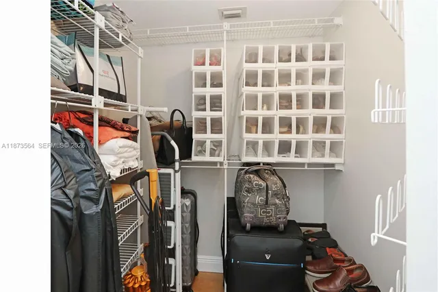 a view of a closet with storage and utility room