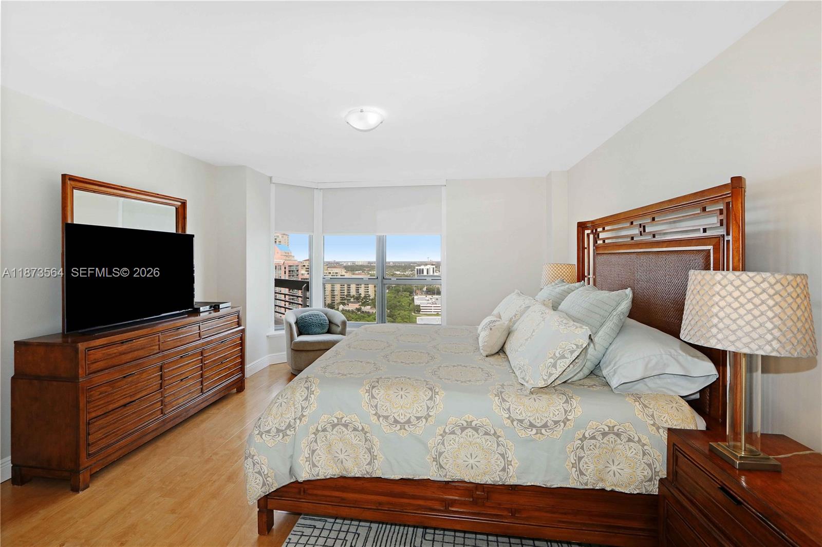 3530 Mystic Pointe Drive, Unit 2402 Aventura, FL 33180 - Photo 8 of 31 a bedroom with a bed and flat screen tv