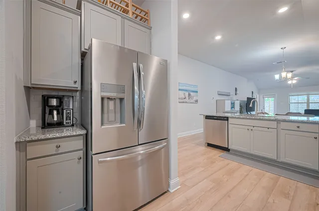 a kitchen with stainless steel appliances a refrigerator sink and cabinets
