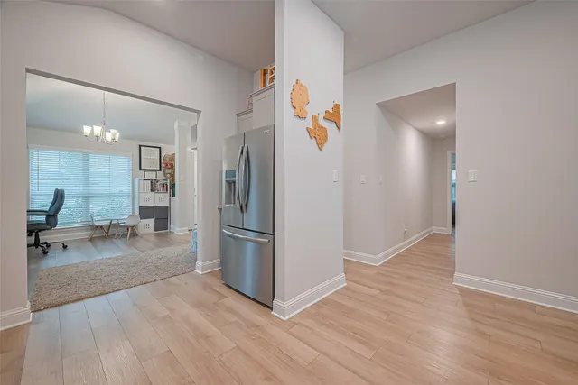 a view of kitchen with furniture and refrigerator