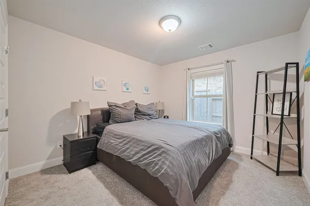 a bedroom with a bed and a table