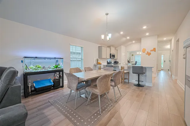 a view of a dining room with furniture window and wooden floor