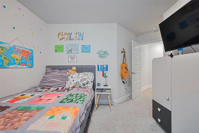 a bedroom with furniture and flat screen tv