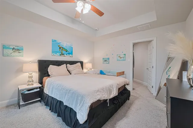 a bedroom with bed and a chandelier