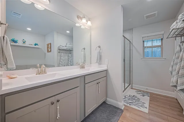 a bathroom with a sink double vanity granite and a mirror