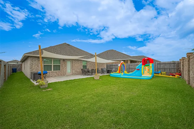 a view of an house with backyard space and garden