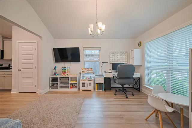 a view of a livingroom with workspace and a window