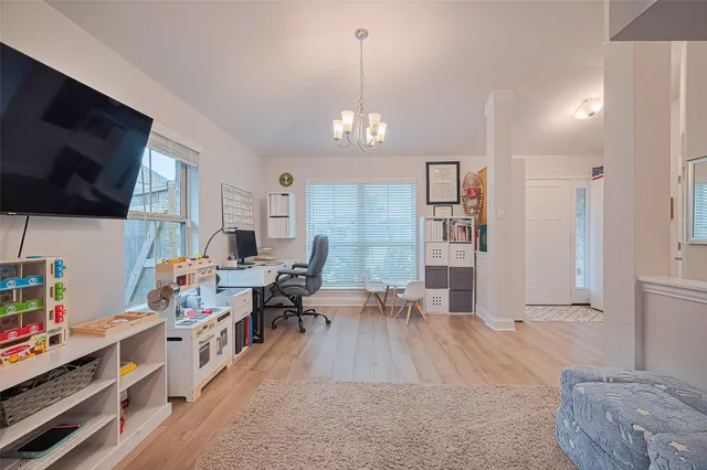 a view of a livingroom with workspace and a window