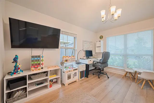 a view of a workspace with furniture and a window