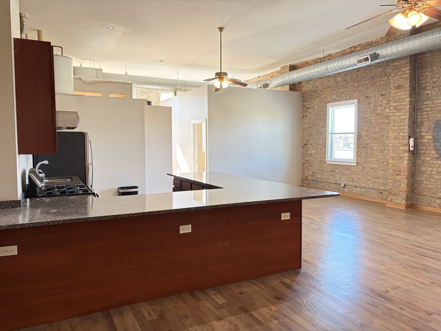 2727 South Archer Avenue, Unit 2 Chicago, IL 60608 - Photo 2 of 7 a kitchen with a sink cabinets and wooden floor