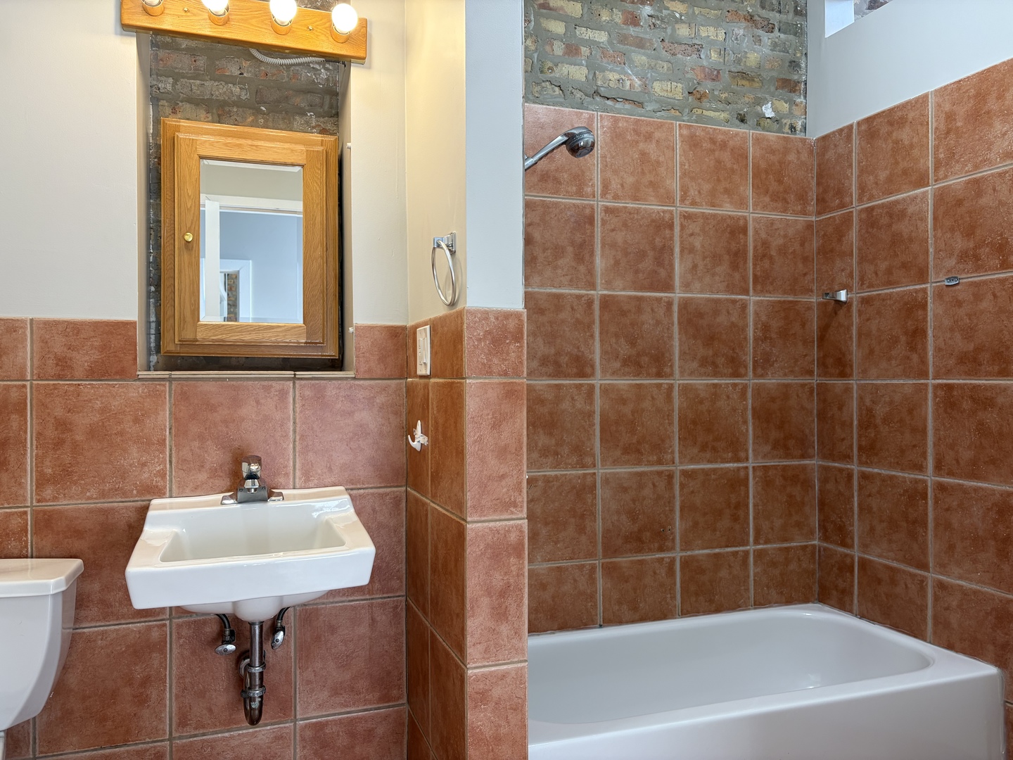 2727 South Archer Avenue, Unit 2 Chicago, IL 60608 - Photo 3 of 7 a bathroom with a sink a window and a shower