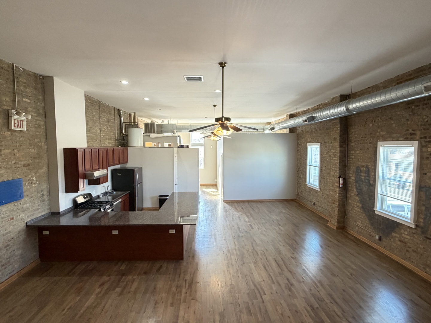 2727 South Archer Avenue, Unit 2 Chicago, IL 60608 - Photo 5 of 7 a view of a workspace with furniture and chandelier