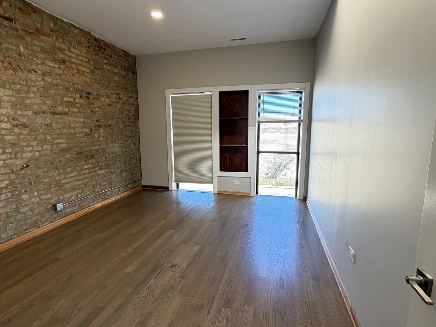 2727 South Archer Avenue, Unit 2 Chicago, IL 60608 - Photo 6 of 7 wooden floor in an empty room with a window