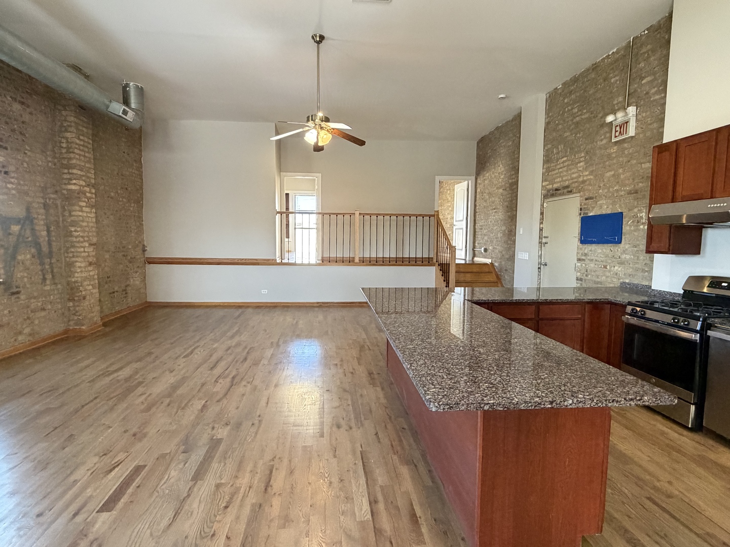 2727 South Archer Avenue, Unit 2 Chicago, IL 60608 - Photo 7 of 7 a kitchen with stainless steel appliances granite countertop a sink a stove and a wooden floors