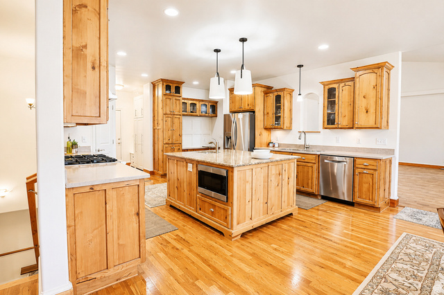 1055 North 1000 East Mapleton, UT 84664 - Photo 28 of 112 Kitchen featuring a central island with built-in microwave, wood-finish flooring, recessed lighting, and stainless steel appliances