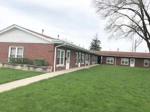 a view of a house with a yard and porch