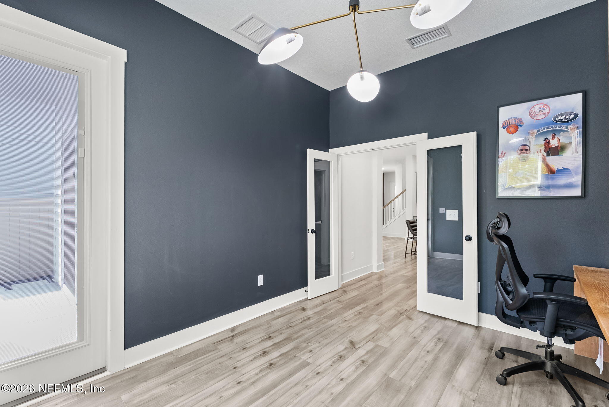 9989 Element Road Jacksonville, FL 32256 - Photo 18 of 58 a view of a workspace with furniture and a window