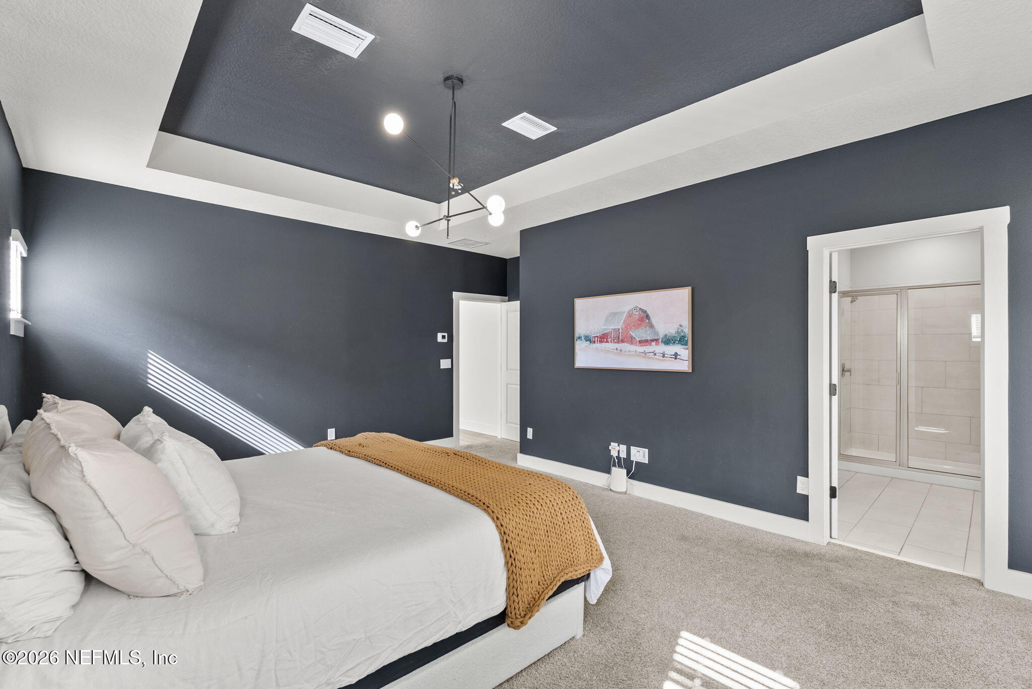 9989 Element Road Jacksonville, FL 32256 - Photo 24 of 58 a bedroom with a bed and a lamp on the table