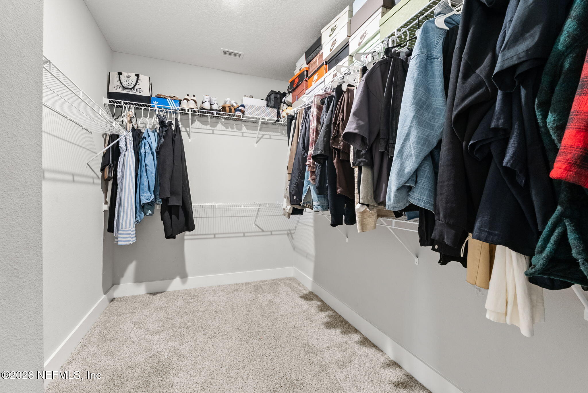 9989 Element Road Jacksonville, FL 32256 - Photo 28 of 58 a view of walk in closet with clothes and shoes