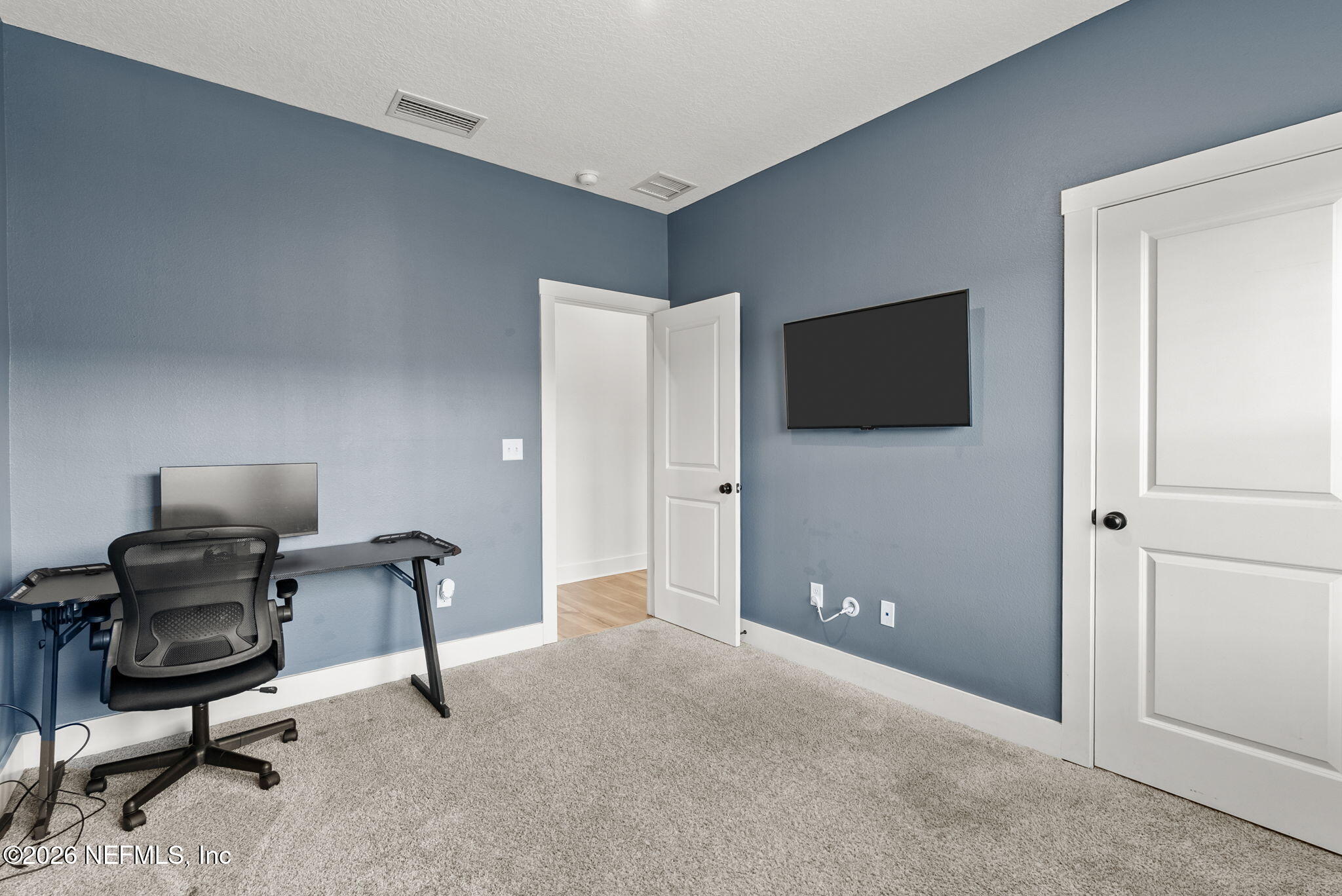 9989 Element Road Jacksonville, FL 32256 - Photo 32 of 58 a view of a livingroom with furniture and a flat screen tv