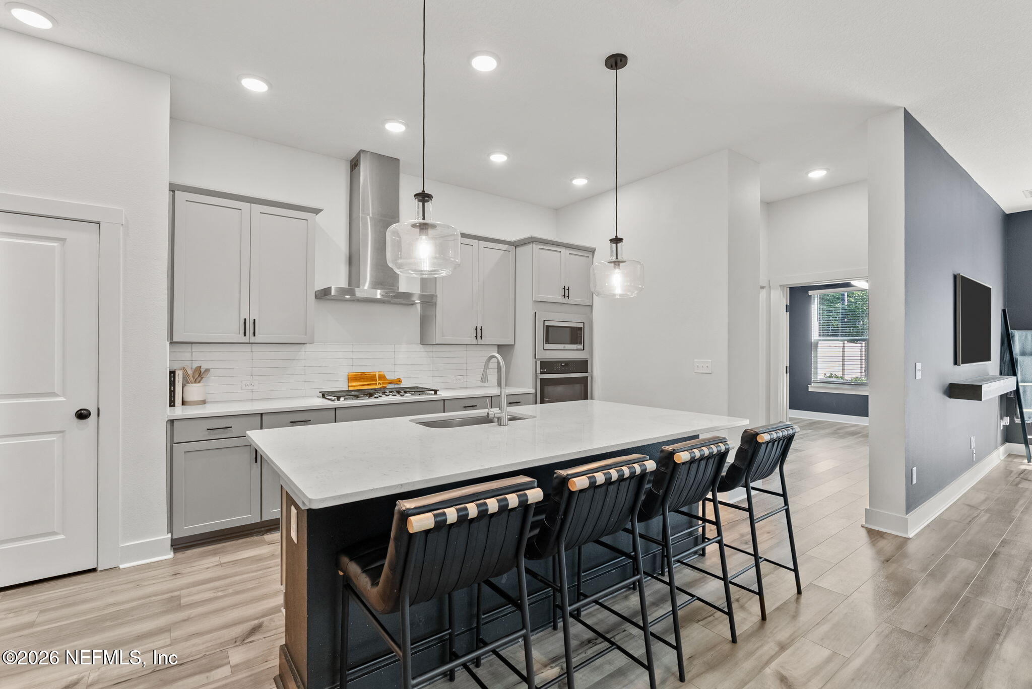 9989 Element Road Jacksonville, FL 32256 - Photo 5 of 58 a kitchen with kitchen island a dining table and chairs