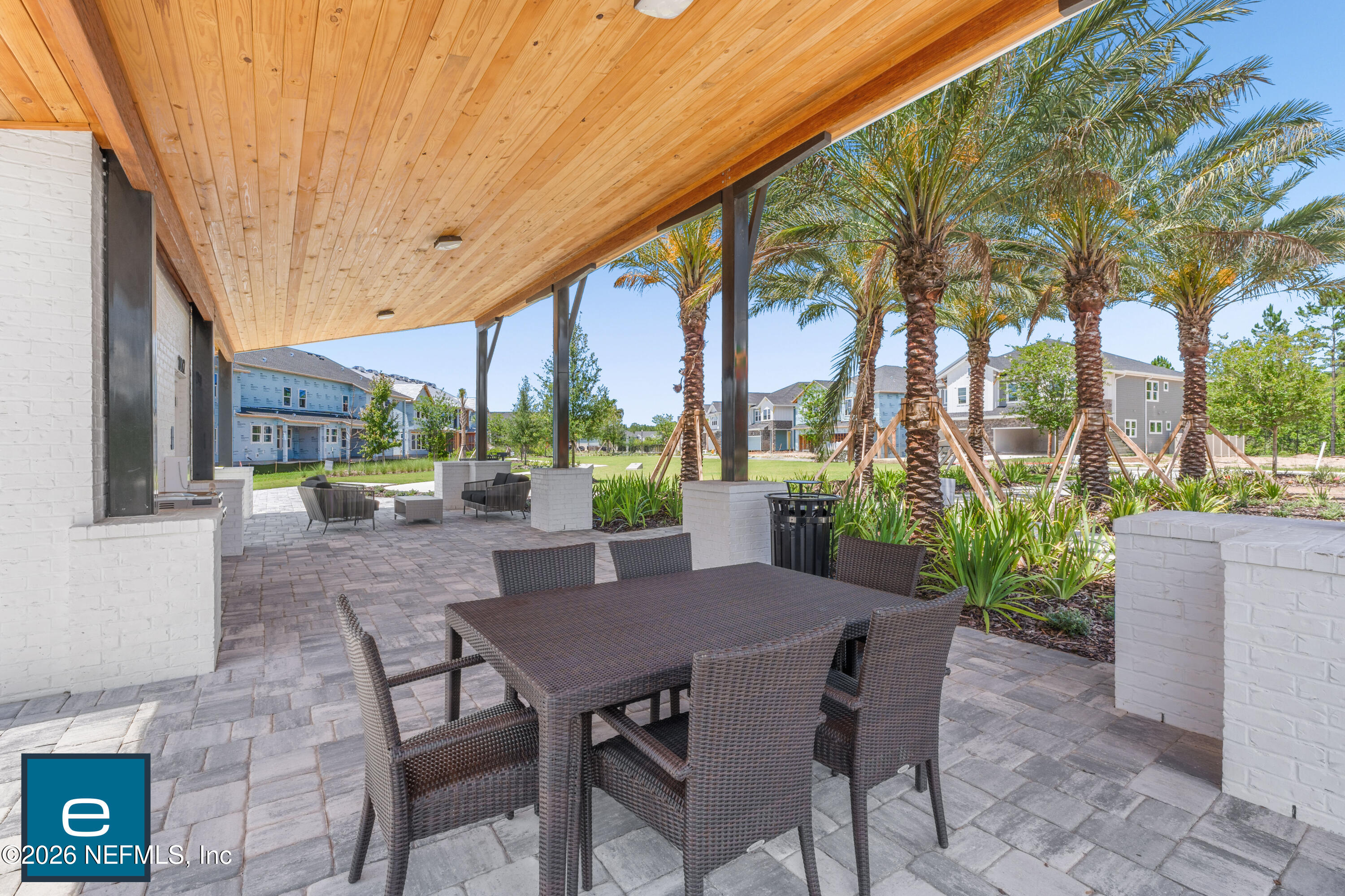 9989 Element Road Jacksonville, FL 32256 - Photo 57 of 58 a view of a patio with table and chairs potted plants and floor to ceiling window