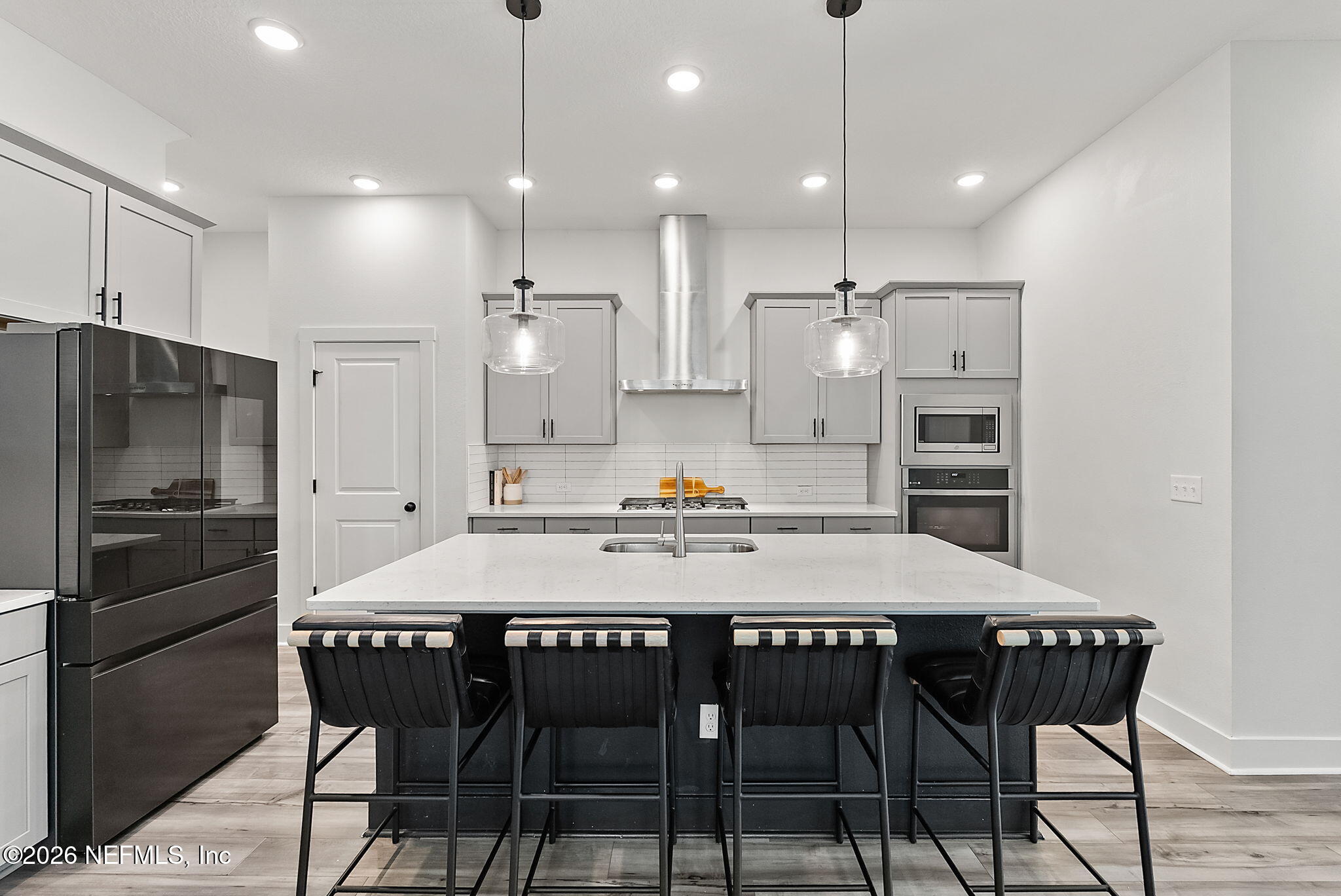 9989 Element Road Jacksonville, FL 32256 - Photo 6 of 58 a kitchen with a dining table chairs stainless steel appliances and cabinets