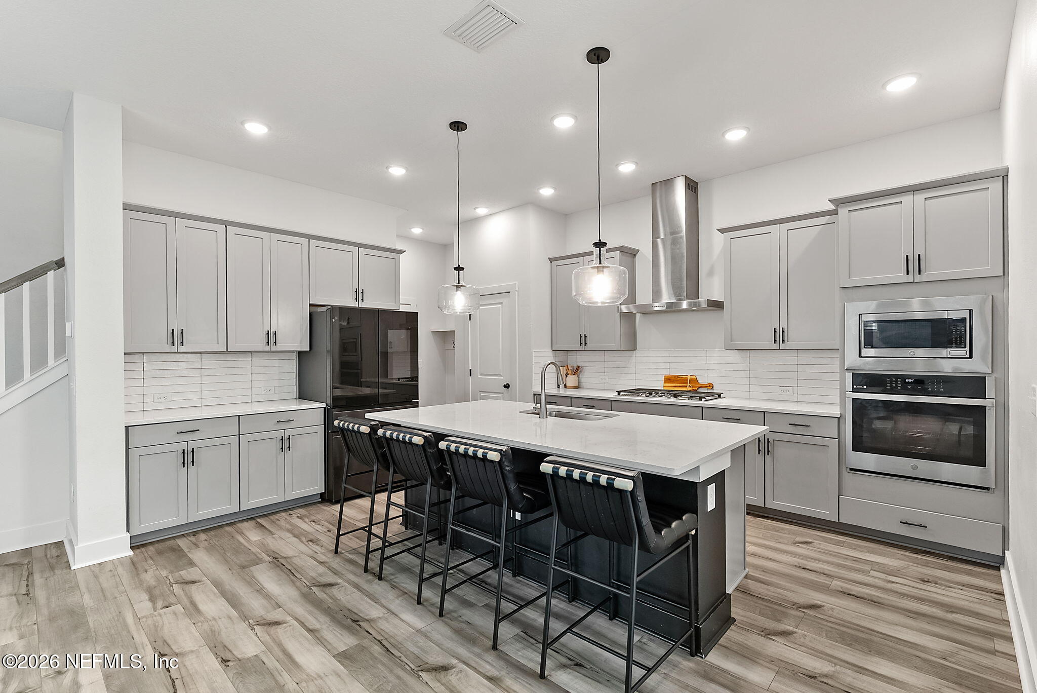 9989 Element Road Jacksonville, FL 32256 - Photo 7 of 58 a kitchen with a stove a sink and a refrigerator