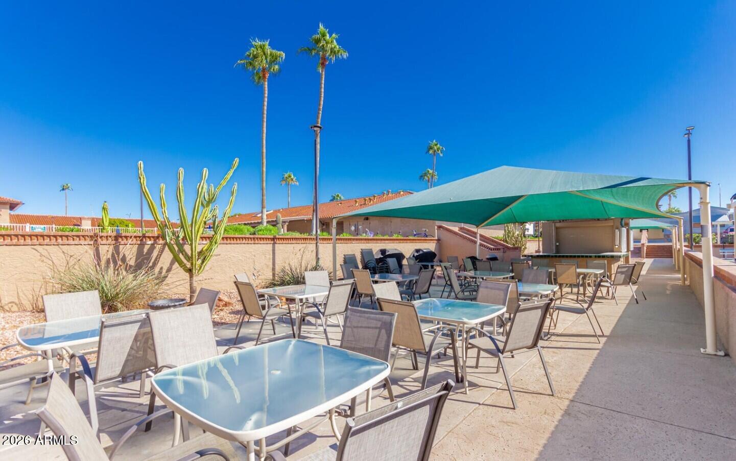 111 South Greenfield Road, Unit 90 Mesa, AZ 85206 - Photo 11 of 26 a view of a patio with a table and chairs under an umbrella