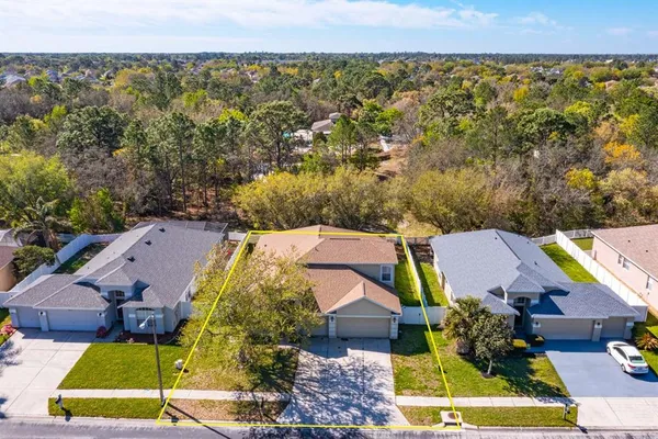 an aerial view of a house with swimming pool and garden