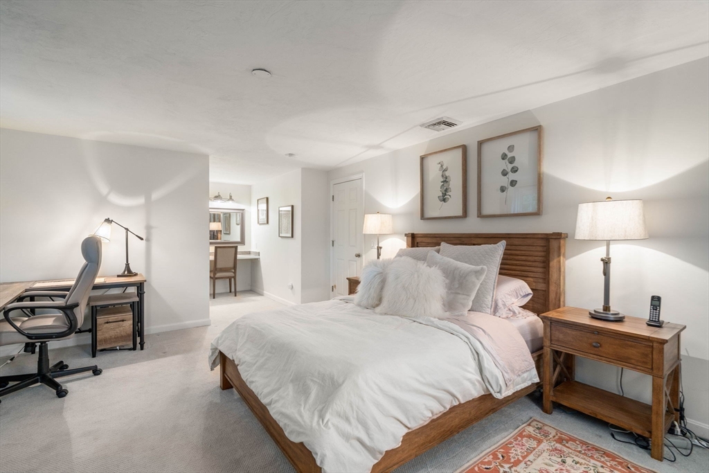 5 Cherry Brook Circle Sturbridge, MA 01566 - Photo 24 of 31 a bedroom with a bed and a lamp on dresser