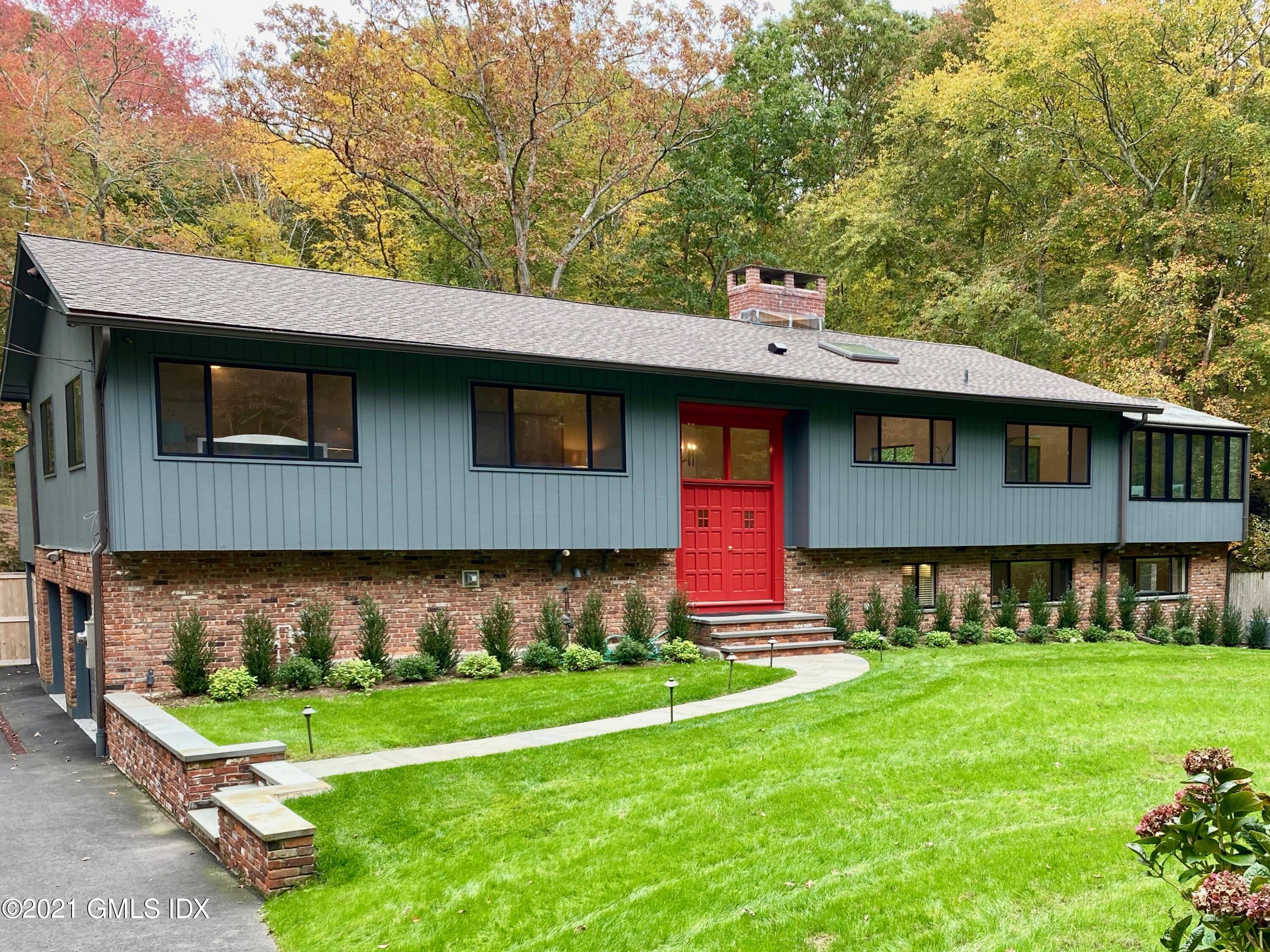a front view of house with yard and green space
