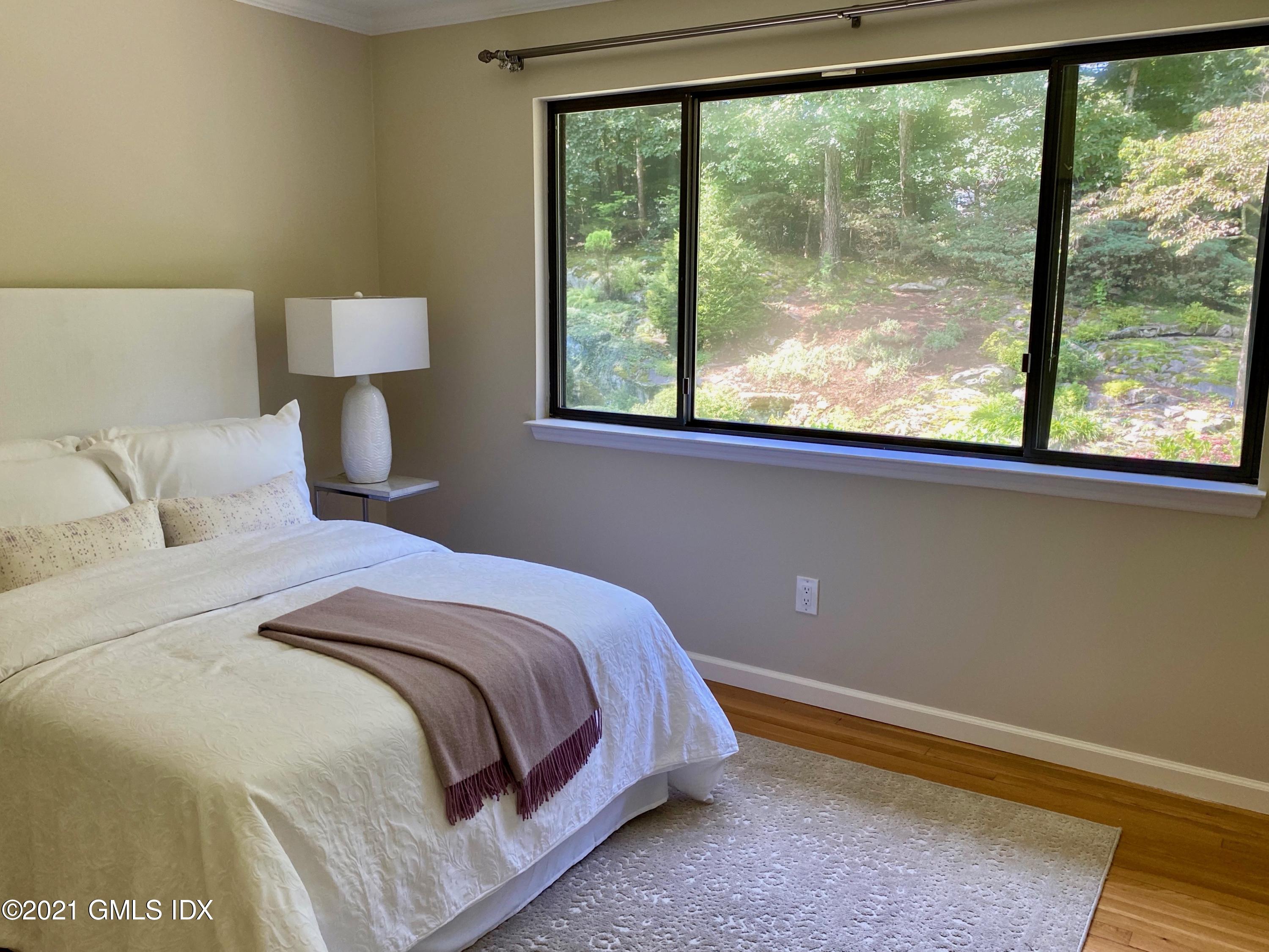 297 Cognewaugh Road Cos Cob, CT 06807 - Photo 11 of 25 a bedroom with a bed and a window