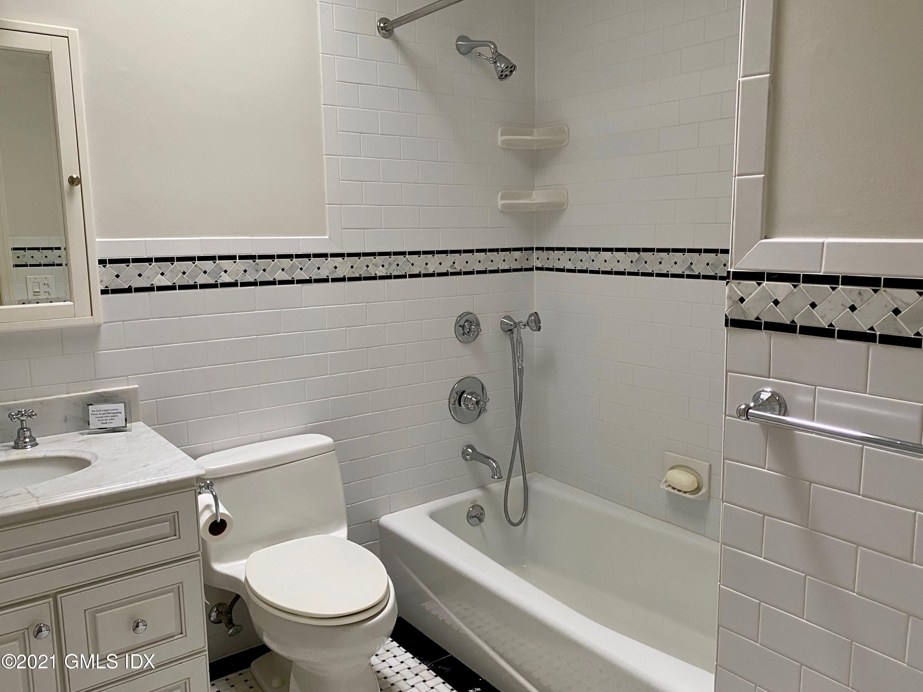 297 Cognewaugh Road Cos Cob, CT 06807 - Photo 12 of 25 a bathroom with a sink a toilet and a shower
