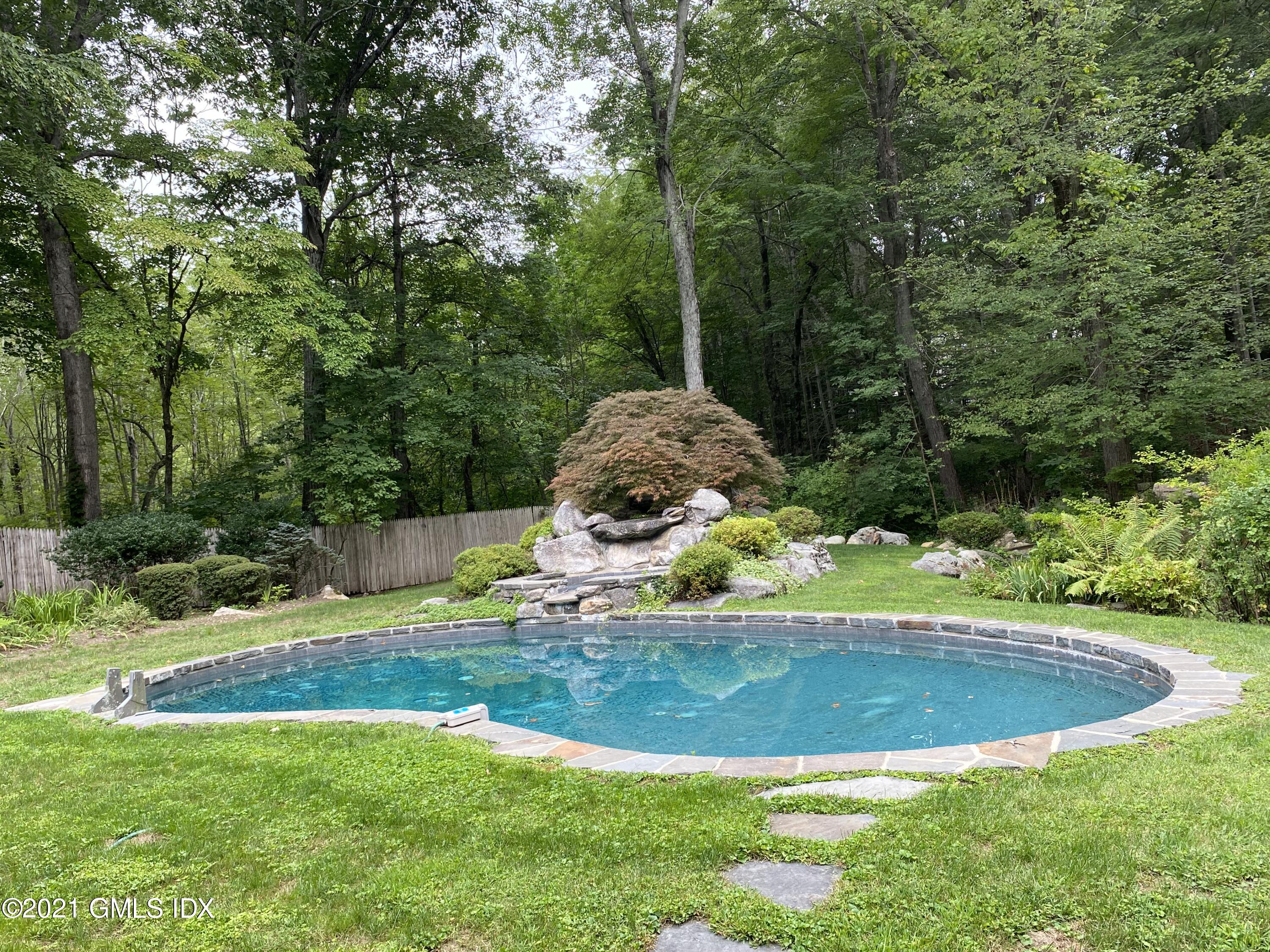 297 Cognewaugh Road Cos Cob, CT 06807 - Photo 19 of 25 a view of a backyard with swimming pool